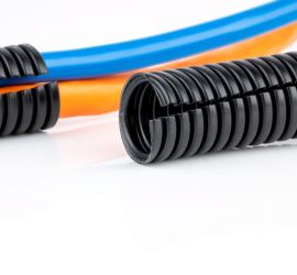 Black corrugated tubing, standard issue, with a piece of corrugated tubing with cables guided through it in the background.