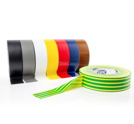 Eight rolls of PVC tape next to each other in the colors black, gray, white, yellow, red, blue and brown, and a yellow/green roll lying in front of it, on a white background.